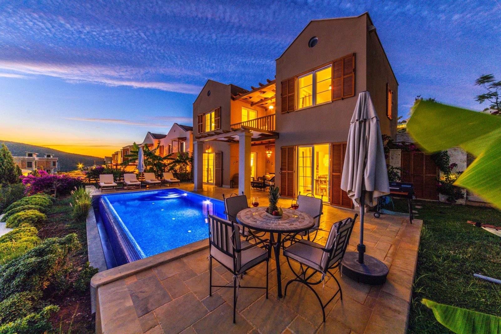 Home exterior illuminated at dusk