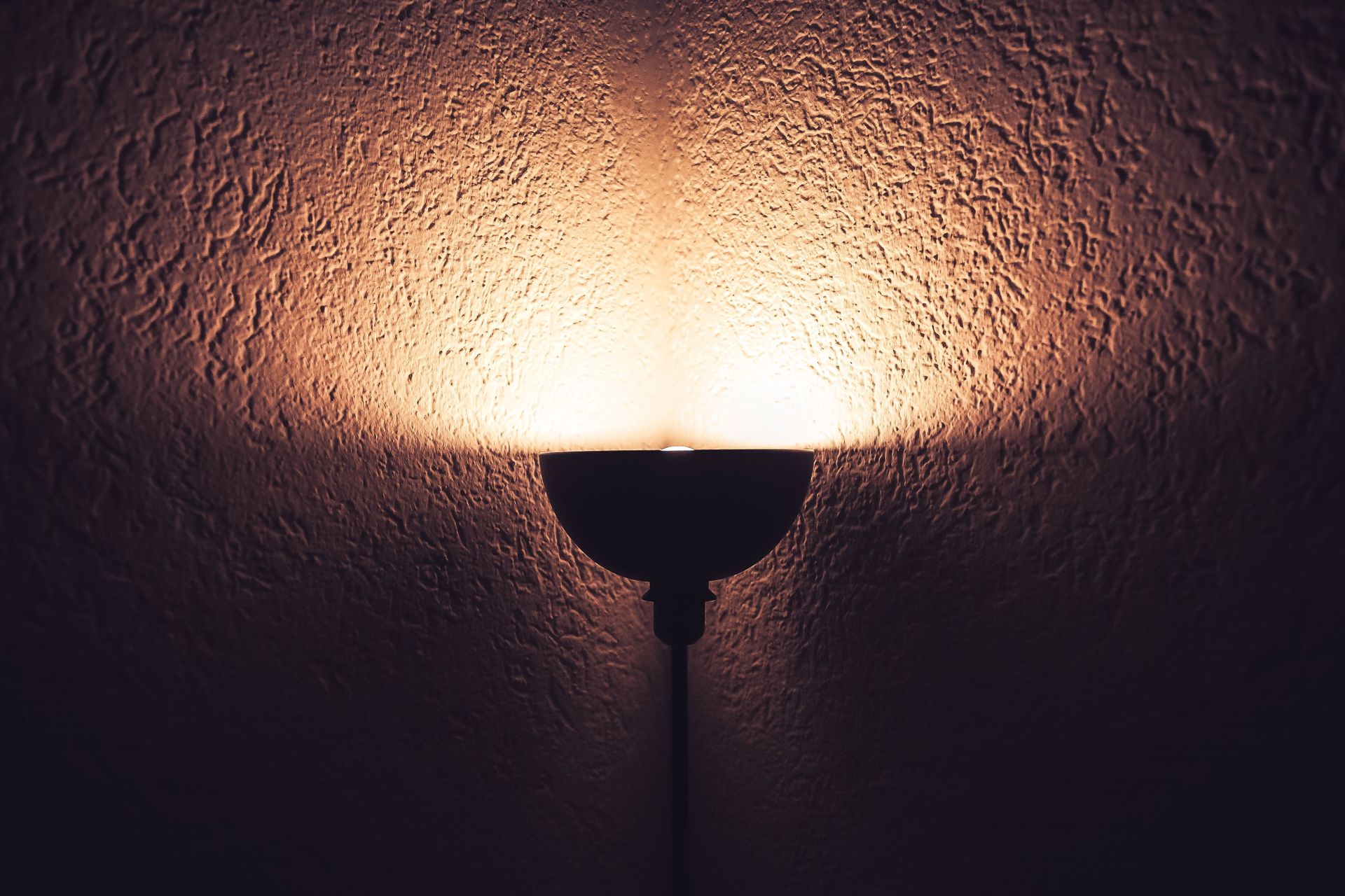 Minimalist wall light glowing at night